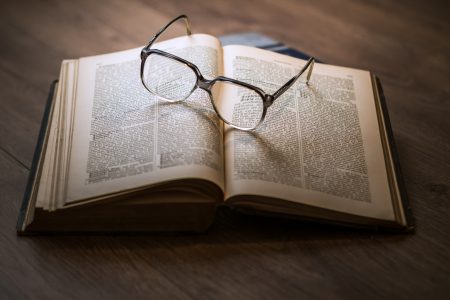 open book with glasses on top